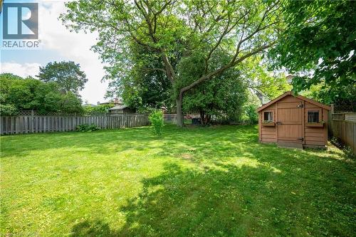 Expansive backyard featuring a manicured lawn and mature trees - 99 Lorraine Avenue, Kitchener, ON - Outdoor