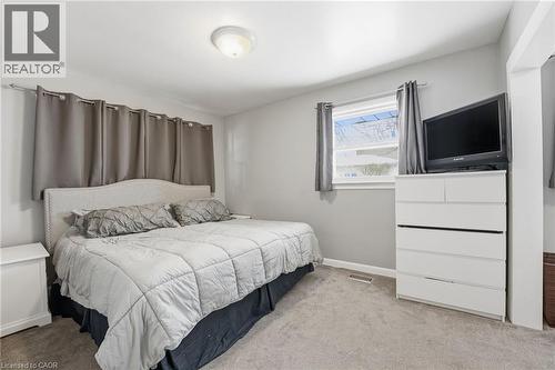 Bedroom with carpet and baseboards - 473 Mohawk Road W, Hamilton, ON 