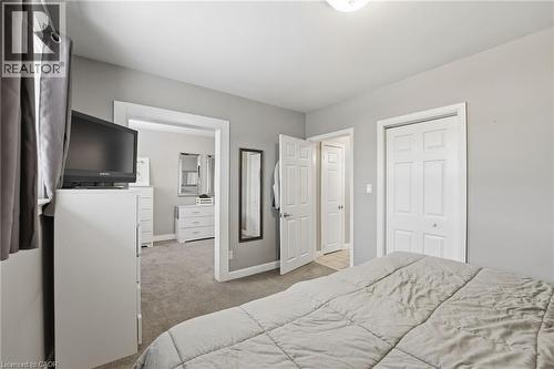 Bedroom featuring light carpet and a closet - 473 Mohawk Road W, Hamilton, ON 