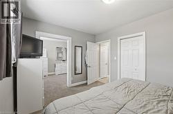 Bedroom featuring light carpet and a closet - 