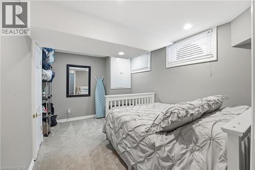 Bedroom with light carpet and recessed lighting - 473 Mohawk Road W, Hamilton, ON 