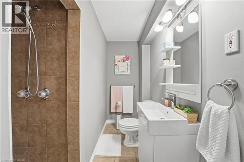 Bathroom featuring a stall shower, vanity, and light tile patterned flooring - 473 Mohawk Road W, Hamilton, ON 