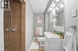 Bathroom featuring a stall shower, vanity, and light tile patterned flooring - 