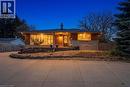 View of front of house featuring a porch, a chimney, stone siding, and brick siding - 473 Mohawk Road W, Hamilton, ON 