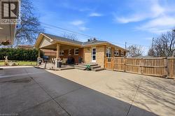 Rear view of property with a patio area, a gate, and brick siding - 