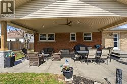 View of patio with ceiling fan and outdoor lounge area - 