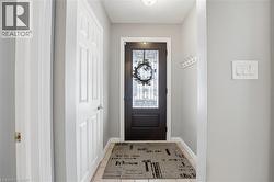Doorway featuring tile patterned floors and a textured ceiling - 
