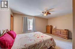 Carpeted room with neutral tone walls and a window with trim - 