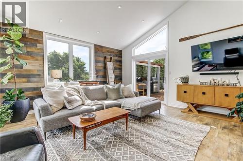 sliding door to upper pool deck - 657 Windham Road 14 Road, Simcoe, ON - Indoor Photo Showing Living Room