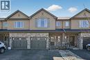 Townhome exterior featuring a stucco and stone facade with multiple gables - 149 Kinsman Drive, Binbrook, ON 