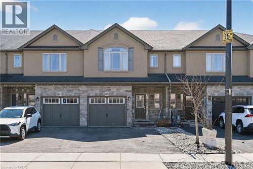 Exterior showcasing stone and stucco facade, gable rooflines, and multiple windows - 149 Kinsman Drive, Binbrook, ON 