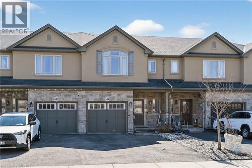 Townhouse exterior featuring a stone and stucco facade - 149 Kinsman Drive, Binbrook, ON 
