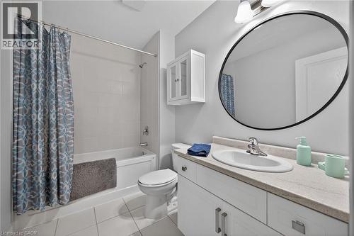 Full bathroom featuring a single vanity with an oval undermount sink, a countertop with a light stone-finish, and white cabinetry - 149 Kinsman Drive, Binbrook, ON 