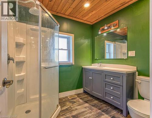 Bathroom featuring a glass-enclosed shower, a vanity with a light countertop, wood-finish flooring, a wood-paneled ceiling, and a window - 84 Franklin Street S, Kitchener, ON - Indoor Photo Showing Bathroom