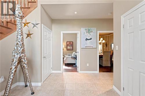 Foyer featuring light-toned tile flooring, neutral wall paint, and white trim - 207 Valridge Drive, Ancaster, ON - Indoor Photo Showing Other Room