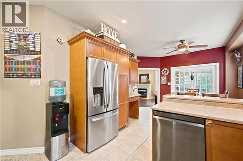 Kitchen featuring wood-finish cabinetry, stainless steel appliances, and tile flooring - 207 Valridge Drive, Ancaster, ON - Indoor Photo Showing Kitchen
