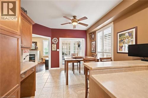 Kitchen area featuring warm wood cabinetry, light-toned countertops, and square tile flooring - 207 Valridge Drive, Ancaster, ON - Indoor