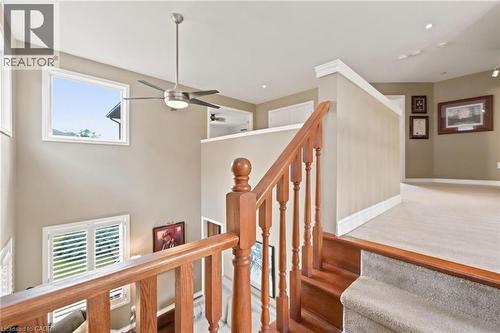 Second level landing open to main floor featuring wood staircase with matching wood balusters and handrail, carpeted landing, recessed lighting, and a ceiling fan - 207 Valridge Drive, Ancaster, ON - Indoor Photo Showing Other Room