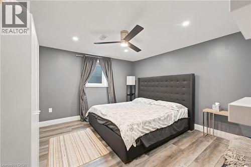 Bedroom featuring wood-finish flooring, recessed lighting, and a modern ceiling fan - 207 Valridge Drive, Ancaster, ON - Indoor Photo Showing Bedroom