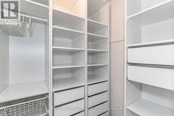 Primary bedroom walk in closet - 