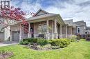 Brick and stone exterior featuring a covered front porch with substantial columns - 219 Falconridge Drive, Kitchener, ON  - Outdoor 