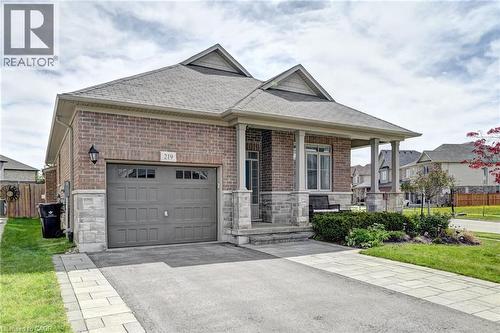 Brick and stone facade with a covered front porch featuring square columns - 219 Falconridge Drive, Kitchener, ON - Outdoor