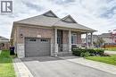 Brick and stone facade with a covered front porch featuring square columns - 219 Falconridge Drive, Kitchener, ON  - Outdoor 