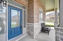 Inviting front entry featuring a bold blue door with glass lites, sidelights, and a transom window - 219 Falconridge Drive, Kitchener, ON  - Outdoor With Exterior 