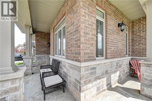 Covered front porch featuring brick and stone veneer siding - 219 Falconridge Drive, Kitchener, ON - Outdoor With Deck Patio Veranda With Exterior
