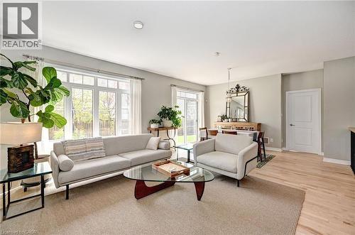 Open-concept living space with extensive natural light from large windows and a sliding glass door - 219 Falconridge Drive, Kitchener, ON - Indoor Photo Showing Living Room