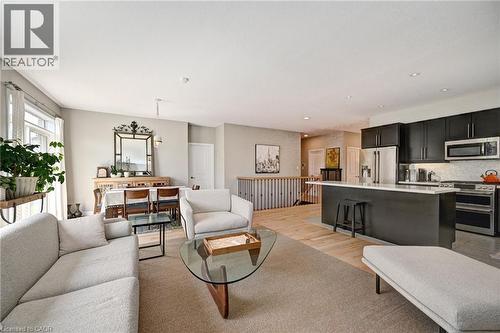 Open-concept living area featuring light-toned walls and recessed lighting - 219 Falconridge Drive, Kitchener, ON - Indoor Photo Showing Living Room