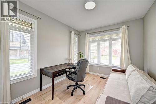 Bright room featuring light wood-finish flooring, neutral wall tones, and white trim - 219 Falconridge Drive, Kitchener, ON - Indoor