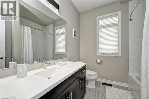 Bathroom featuring a dark wood-finish vanity with a white countertop and integrated sink - 219 Falconridge Drive, Kitchener, ON - Indoor Photo Showing Bathroom