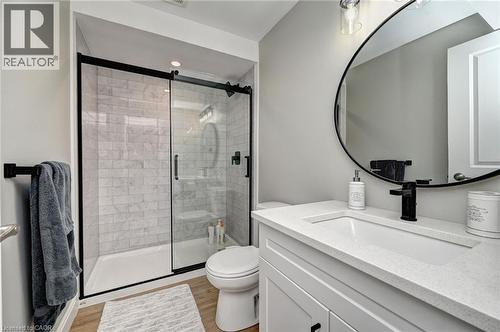 Modern bathroom featuring a walk-in shower with subway tile surround and a sliding glass door with matte black framing - 219 Falconridge Drive, Kitchener, ON - Indoor Photo Showing Bathroom