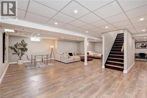 Spacious lower level featuring wood-finish flooring, recessed lighting, and a drop ceiling - 219 Falconridge Drive, Kitchener, ON - Indoor