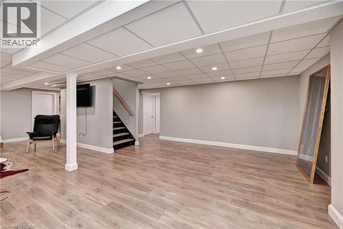 Spacious room featuring wood-finish flooring, recessed lighting, and a drop ceiling - 219 Falconridge Drive, Kitchener, ON - Indoor Photo Showing Other Room