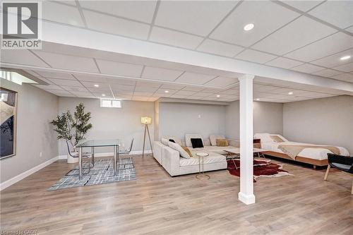 Spacious lower-level area featuring recessed lighting, light wood-finish flooring, and white baseboards - 219 Falconridge Drive, Kitchener, ON - Indoor Photo Showing Other Room