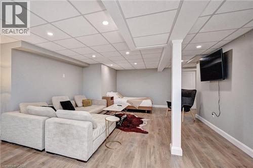 Spacious room with wood-finish flooring, recessed lighting, and a drop ceiling - 219 Falconridge Drive, Kitchener, ON - Indoor