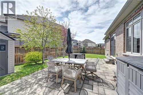 Spacious backyard featuring a paver patio, manicured lawn, and a privacy fence - 219 Falconridge Drive, Kitchener, ON - Outdoor With Deck Patio Veranda With Exterior