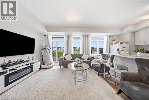Open-concept living area, multiple large windows, and direct access to an outdoor space - 176 Wheat Lane, Kitchener, ON - Indoor Photo Showing Living Room