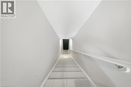 Staircase with light-toned steps and a white wall-mounted handrail - 176 Wheat Lane, Kitchener, ON - Indoor Photo Showing Other Room