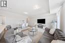 Open-concept living area featuring light wood-finish flooring, recessed lighting, and a white electric fireplace with media console - 176 Wheat Lane, Kitchener, ON  - Indoor Photo Showing Living Room 