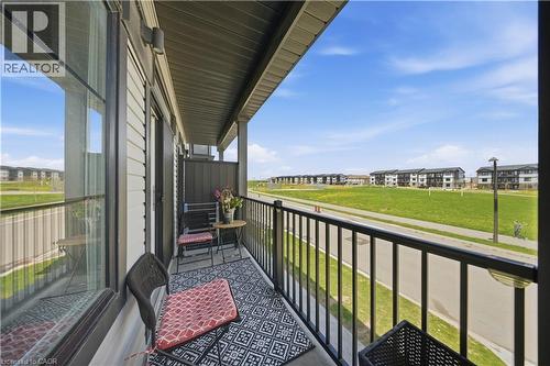 Private balcony featuring a black metal railing and a partial privacy wall - 176 Wheat Lane, Kitchener, ON - Outdoor With Balcony With Exterior