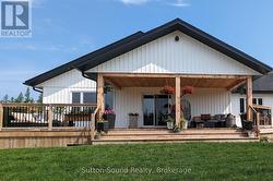 Large covered back deck overlooking the open space - 