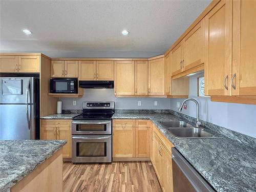28 White Ash Drive, Brandon, MB - Indoor Photo Showing Kitchen With Stainless Steel Kitchen With Double Sink