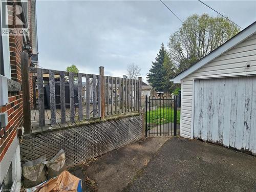 Outdoor wooden deck with lattice skirting and privacy fencing - 75 Barons Avenue S, Hamilton, ON - Outdoor