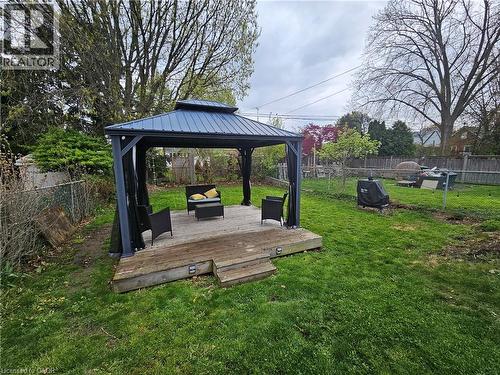 Spacious backyard featuring a gazebo with a metal roof and a raised wooden deck - 75 Barons Avenue S, Hamilton, ON - Outdoor With Deck Patio Veranda With Backyard