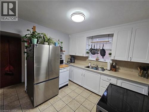 Kitchen featuring stainless steel refrigerator and electric range - 75 Barons Avenue S, Hamilton, ON - Indoor Photo Showing Kitchen With Double Sink