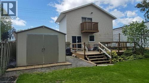 Rear exterior featuring a storage shed, wood deck and second-story balcony. - 257 Cedar Street, Simcoe, ON - Outdoor With Exterior