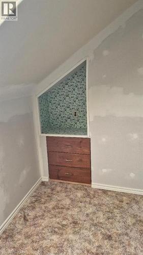 Built-in wood-finish cubby with three drawers and polished chrome hardware. - 257 Cedar Street, Simcoe, ON - Indoor Photo Showing Other Room
